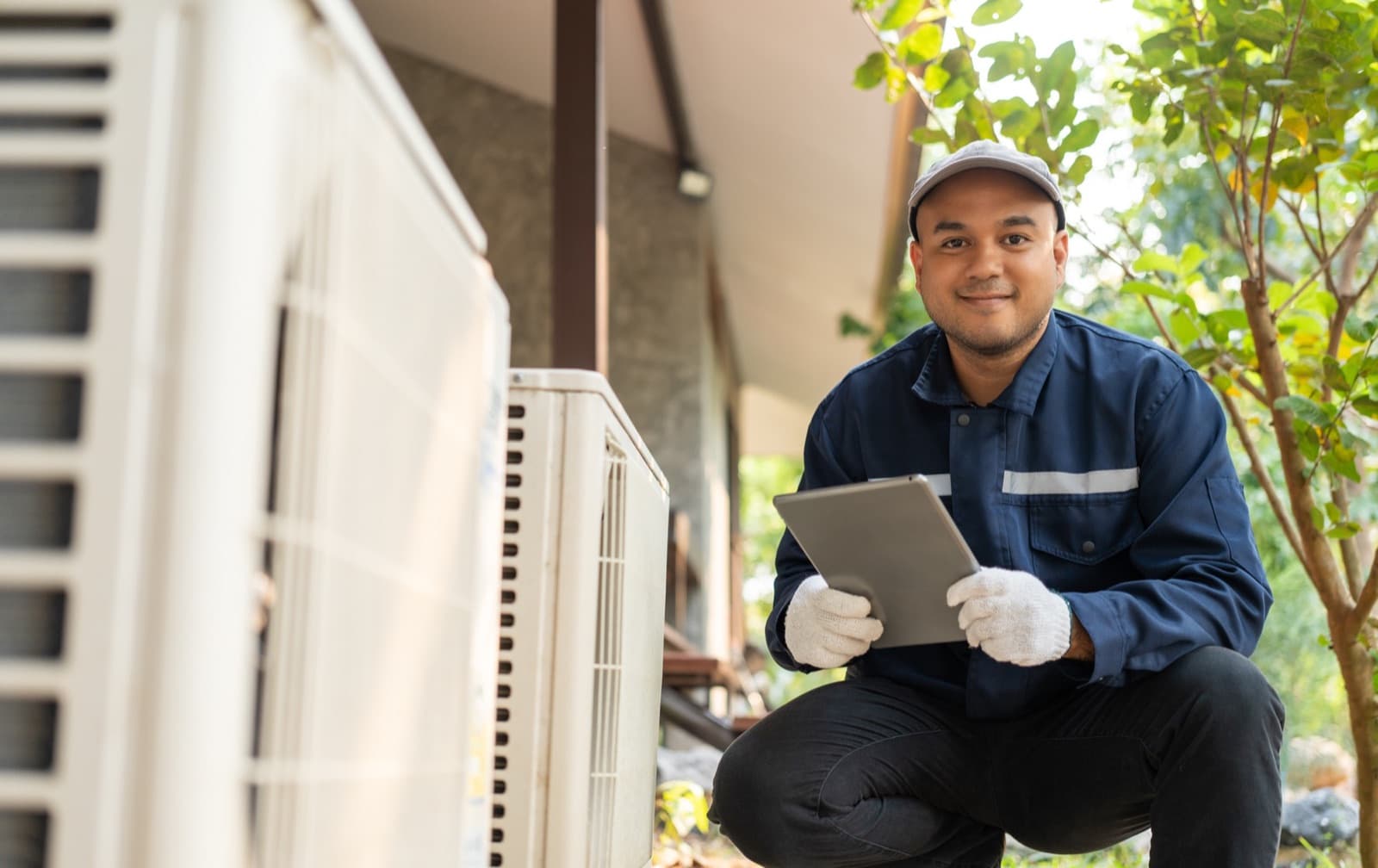 HVAC technician reviewing a project on a tablet at a California job site